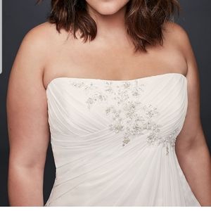 Beautiful strapless wedding dress in wardrobe bag.